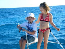 Boy and a girl sailing off Ambergris Caye, Belize – Best Places In The World To Retire – International Living